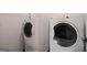 Bright laundry room featuring a full-size, white washer and dryer for added convenience at 3950 Chattahoochee Rd, Cumming, GA 30041
