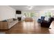 Bright living room featuring a fireplace and large windows that provide ample natural light at 3950 Chattahoochee Rd, Cumming, GA 30041