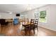 Inviting open-concept living area featuring natural light, hardwood floors, and a cozy fireplace at 3950 Chattahoochee Rd, Cumming, GA 30041