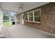 Covered patio with screens, brick walls, and ceiling fan at 3950 Chattahoochee Rd, Cumming, GA 30041
