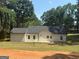An expansive backyard features a manicured lawn and mature trees at 5431 S Lake Dr, Douglasville, GA 30135
