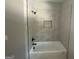 An elegant bathroom showcases a tub with shower head and tiled walls at 5431 S Lake Dr, Douglasville, GA 30135