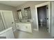 Bathroom boasts dual vanities and framed mirrors next to a water closet at 5431 S Lake Dr, Douglasville, GA 30135
