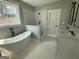 This bathroom has a soaking tub, double vanity and a glass-enclosed shower at 5431 S Lake Dr, Douglasville, GA 30135