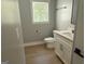 Cozy bathroom with a white vanity and ample natural light from the window at 5431 S Lake Dr, Douglasville, GA 30135