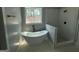 This modern bathroom has a soaking tub next to a glass-enclosed shower at 5431 S Lake Dr, Douglasville, GA 30135