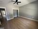 The bright bedroom is empty with wood floors and a ceiling fan at 5431 S Lake Dr, Douglasville, GA 30135