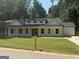 Charming single-Gathering home featuring a covered porch and well-manicured lawn at 5431 S Lake Dr, Douglasville, GA 30135