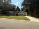 Charming home with an attached garage and a well-manicured lawn on a sunny day at 5431 S Lake Dr, Douglasville, GA 30135