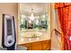 Unique bathroom design with mirrors, a chandelier, and an elevated soaking tub at 1214 Greenridge Ln, Lithonia, GA 30058