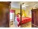 Bedroom featuring ceiling fan, carpet and four-poster bed at 1214 Greenridge Ln, Lithonia, GA 30058