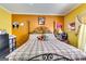 Comfortable bedroom with a decorative iron bed frame and carpet flooring at 1214 Greenridge Ln, Lithonia, GA 30058