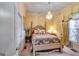 Cozy bedroom featuring a chandelier, four poster bed, neutral decor and a view of a window at 1214 Greenridge Ln, Lithonia, GA 30058