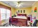 Comfortable bedroom with neutral carpet, a ceiling fan, and decorative window treatments at 1214 Greenridge Ln, Lithonia, GA 30058