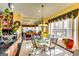Cheerful breakfast nook with a glass table, decorative drapes, and an adjacent kitchen at 1214 Greenridge Ln, Lithonia, GA 30058
