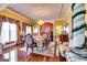 Elegant dining room featuring hardwood floors, formal table setting, and decorative chandelier at 1214 Greenridge Ln, Lithonia, GA 30058