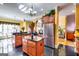Spacious kitchen features stainless steel appliances, cherry cabinets, black countertops, and tile flooring at 1214 Greenridge Ln, Lithonia, GA 30058
