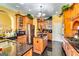 Gourmet kitchen with stainless steel appliances, a central island, and cherry cabinets at 1214 Greenridge Ln, Lithonia, GA 30058