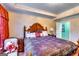Comfortable main bedroom with decorative headboard, ample natural light, and cozy furnishings at 1214 Greenridge Ln, Lithonia, GA 30058