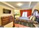 Elegant main bedroom featuring a sitting area, tray ceilings, and large windows for natural light at 1214 Greenridge Ln, Lithonia, GA 30058