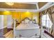 Elegant main bedroom with four poster bed, tray ceiling, and hardwood floors at 1214 Greenridge Ln, Lithonia, GA 30058