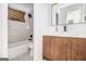 Modern bathroom with a white countertop, wood cabinets and bathtub at 3232 Abbeywood Dr, Decatur, GA 30034