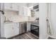 A kitchen featuring stainless steel appliances and white cabinetry and backsplash at 3232 Abbeywood Dr, Decatur, GA 30034