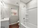 Bright bathroom featuring a shower-tub combination with white tile surround and a single sink vanity at 1030 Westmoor Nw Dr, Atlanta, GA 30314