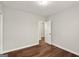 Cozy bedroom featuring hardwood floors, neutral walls, and a door leading to another room at 1030 Westmoor Nw Dr, Atlanta, GA 30314