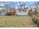 Grey brick home with a covered front porch, complemented by a well-manicured lawn at 1030 Westmoor Nw Dr, Atlanta, GA 30314