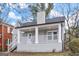 Inviting front porch with white railings and columns on a charming brick home at 1030 Westmoor Nw Dr, Atlanta, GA 30314