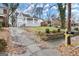 View of the grey brick home, a driveway on the left and the address number is displayed on a wooden post at 1030 Westmoor Nw Dr, Atlanta, GA 30314