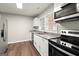 Modern kitchen featuring stainless steel appliances, granite countertops, and hardwood floors at 1030 Westmoor Nw Dr, Atlanta, GA 30314