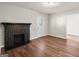 Open-concept living space featuring a black brick fireplace and hardwood floors at 1030 Westmoor Nw Dr, Atlanta, GA 30314