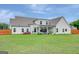 Expansive backyard featuring a well-maintained lawn and a covered porch at 17 Sawtooth Oak Dr, Moreland, GA 30259