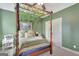 Charming bedroom featuring canopy bed with decorative vines and an olive green painted walls at 17 Sawtooth Oak Dr, Moreland, GA 30259