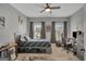Comfortable bedroom with neutral color scheme, large windows, and a ceiling fan at 17 Sawtooth Oak Dr, Moreland, GA 30259