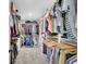 Walk-in closet with rods and shelving for optimal storage and organization at 17 Sawtooth Oak Dr, Moreland, GA 30259
