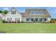 Charming two-story home featuring a welcoming front porch and lush green lawn at 17 Sawtooth Oak Dr, Moreland, GA 30259
