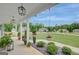Spacious covered porch featuring hanging planters, meticulous landscaping, and neighborhood views at 17 Sawtooth Oak Dr, Moreland, GA 30259