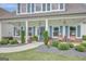 Inviting front porch featuring elegant hanging lanterns, potted plants, and comfortable seating at 17 Sawtooth Oak Dr, Moreland, GA 30259