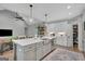 Spacious kitchen with island seating, pendant lighting, and stainless steel appliances at 17 Sawtooth Oak Dr, Moreland, GA 30259