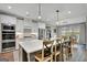 Modern kitchen with a large island, pendant lights, and stainless steel appliances at 17 Sawtooth Oak Dr, Moreland, GA 30259