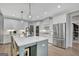 Modern kitchen features white cabinetry, stainless steel appliances, and an island at 17 Sawtooth Oak Dr, Moreland, GA 30259