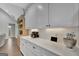 Bright kitchen showcasing white cabinets, quartz countertops, and modern appliances at 17 Sawtooth Oak Dr, Moreland, GA 30259