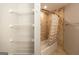 A bathroom storage area and shower/tub with tan tile at 1017 Ridgefield Dr, Peachtree City, GA 30269