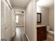 A hallway with a closet, leading to a view of the bedroom and bathroom at 1017 Ridgefield Dr, Peachtree City, GA 30269