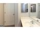A bathroom with a door, large mirror, and sink with a white countertop at 1017 Ridgefield Dr, Peachtree City, GA 30269