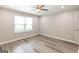 This bedroom is bright with wood-look floors, a ceiling fan, and a window for lots of light at 1017 Ridgefield Dr, Peachtree City, GA 30269