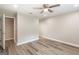 Spacious bedroom with wood-look floors, a ceiling fan, and a doorway leading to closet space at 1017 Ridgefield Dr, Peachtree City, GA 30269